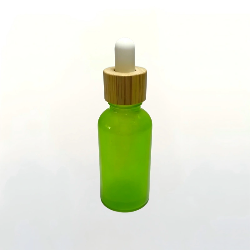 30ml translucent green glass dropper bottle with natural bamboo cap for essential oils and serum packaging